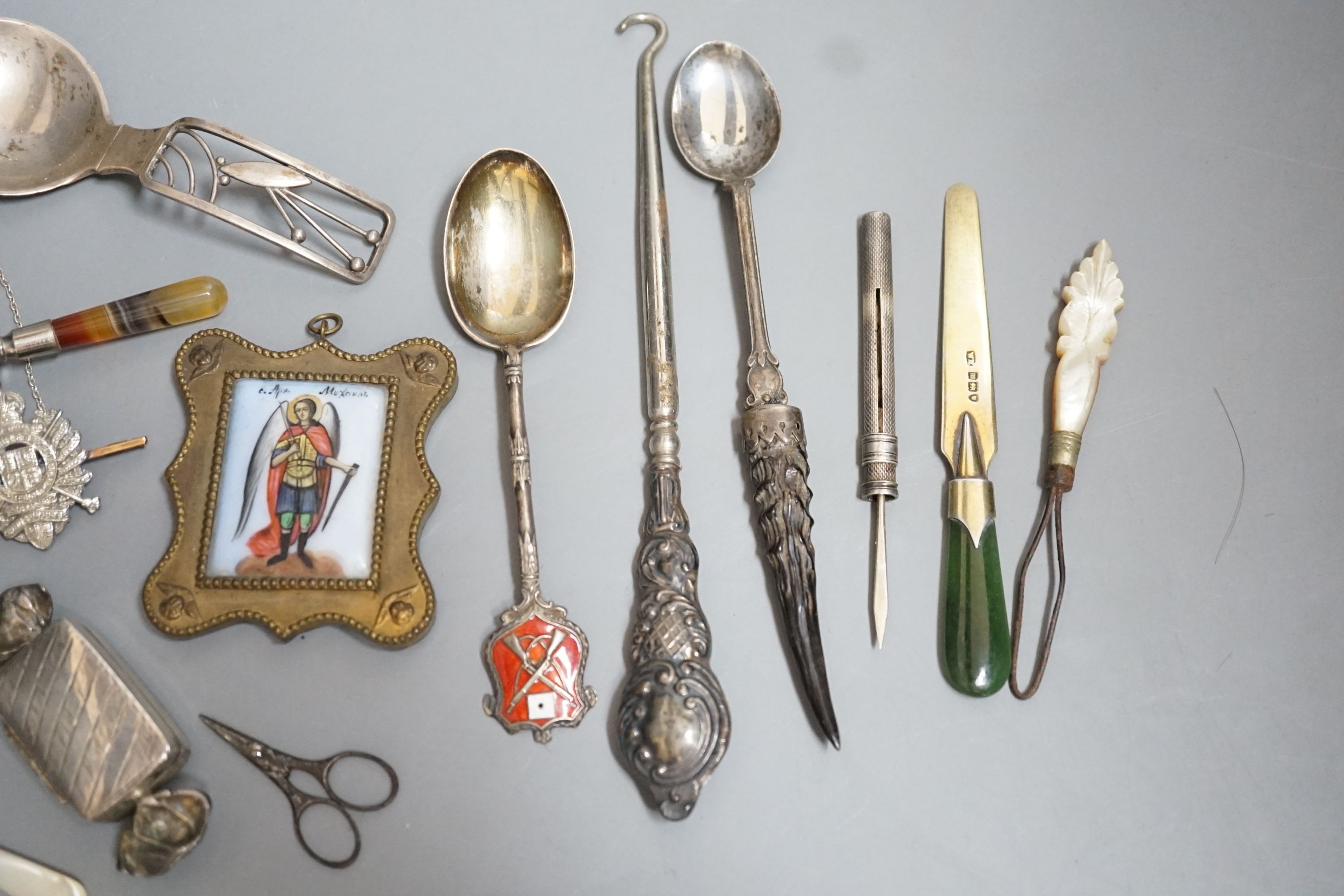 Sundry small silver etc. including a Danish sterling caddy spoon, by Franz Hingelberg, 9.7cm, nephrite handles silver gilt paper knife, swizzle stick, button hook, agate handled trowel bookmark, two badges etc.